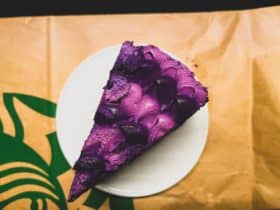 a piece of purple cake sitting on top of a white plate